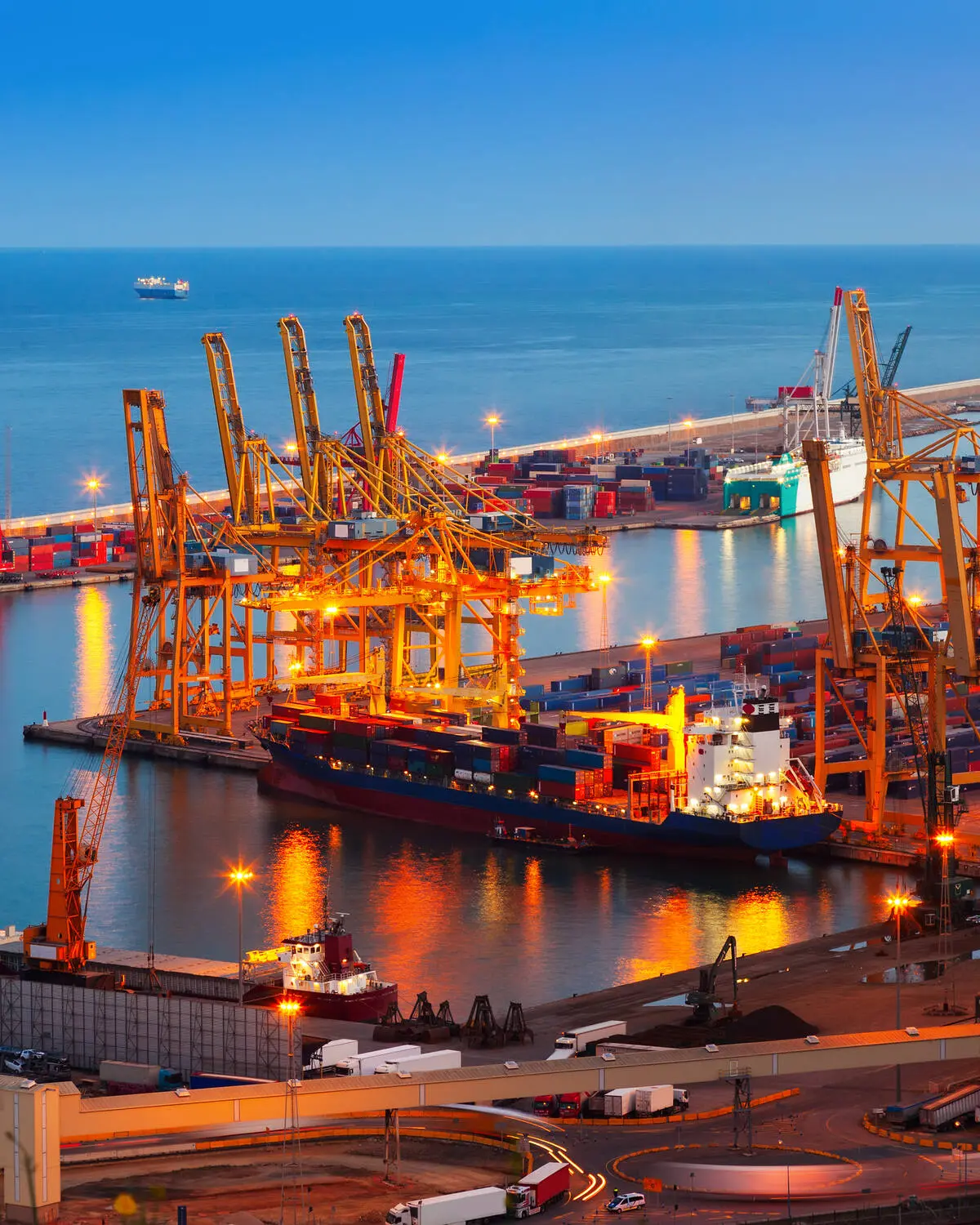 Container port with cranes lit up at night