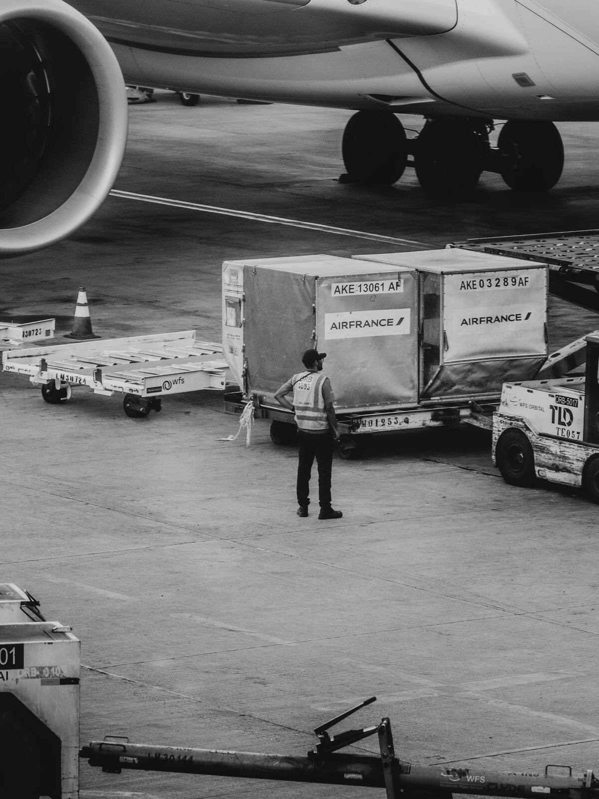 Ground crew loading air cargo containers beside an aircraft